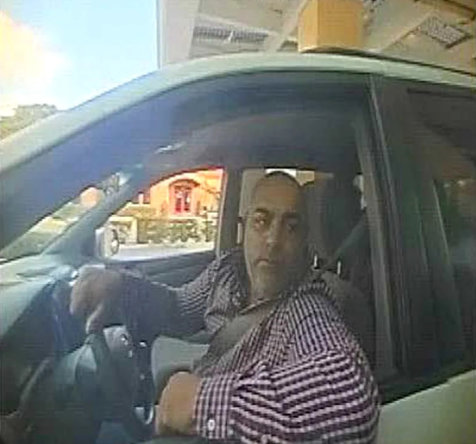 Nicolae Gindac, a member of a criminal ring, deposits stolen church funds into a drop account at a Hollywood, Florida bank. <cite><a href="https://www.documentcloud.org/documents/23809210-commplaint-with-photo-of-criminal-withdrawing-money" rel="nofollow noopener" target="_blank" data-ylk="slk:Court Records;elm:context_link;itc:0" class="link rapid-noclick-resp">Court Records</a></cite>